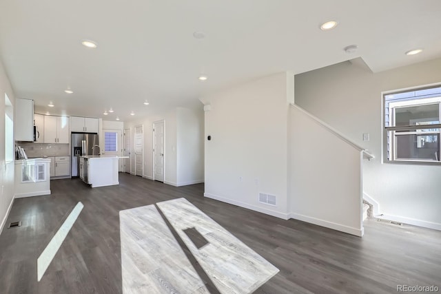 unfurnished living room with dark hardwood / wood-style floors