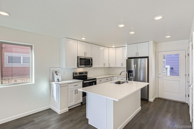 kitchen featuring white cabinets, appliances with stainless steel finishes, and sink