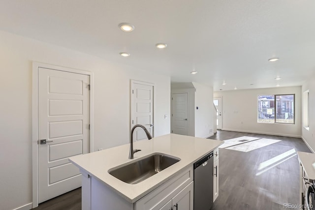 kitchen featuring a center island with sink, stainless steel dishwasher, dark hardwood / wood-style flooring, sink, and white cabinetry