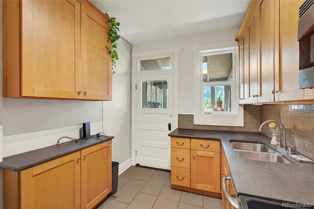 3421 E 16th Ave, Denver, CO 80206 - kitchen with dark countertops, decorative backsplash, and light tile patterned floors