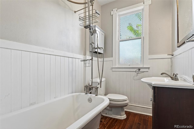 3421 E 16th Ave, Denver, CO 80206 - bathroom featuring a freestanding bath, a wainscoted wall, wood finished floors, and vanity