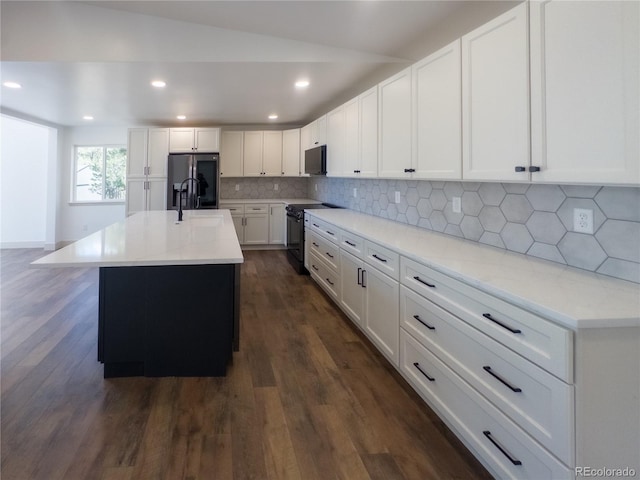 14546 Pine View Rd, Larkspur, CO 80118 - kitchen featuring black / electric stove, stainless steel fridge, white cabinets, recessed lighting, and tasteful backsplash