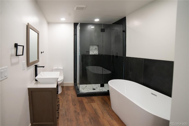 14546 Pine View Rd, Larkspur, CO 80118 - full bath featuring wood finished floors, a soaking tub, vanity, a shower stall, and toilet