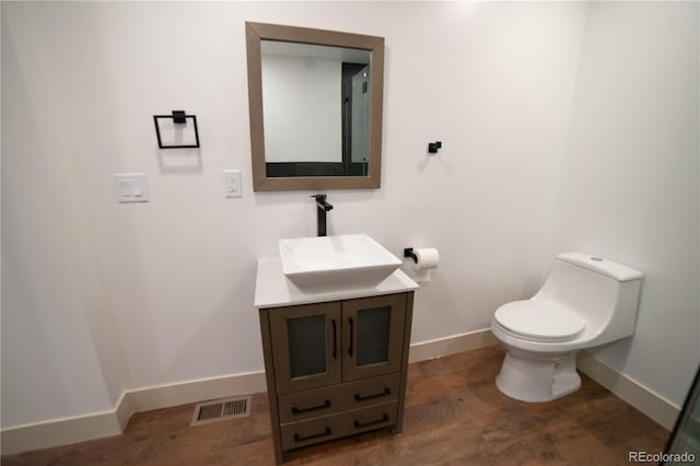 14546 Pine View Rd, Larkspur, CO 80118 - half bath with wood finished floors, baseboards, toilet, and vanity