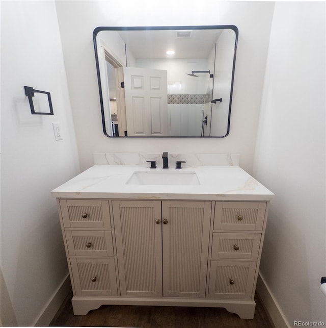 14546 Pine View Rd, Larkspur, CO 80118 - bathroom featuring vanity, wood finished floors, and baseboards