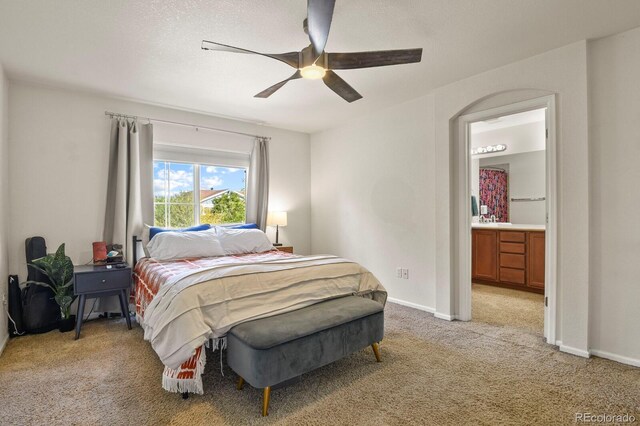 carpeted bedroom featuring ceiling fan, sink, and ensuite bathroom