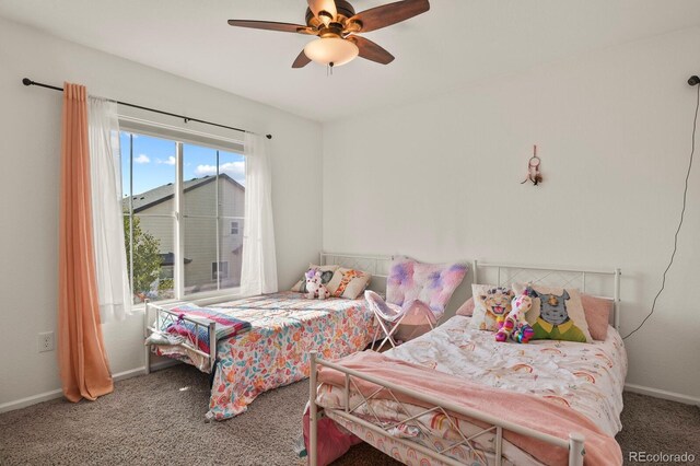 carpeted bedroom featuring ceiling fan and multiple windows