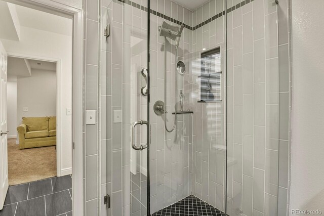 bathroom with a shower with door