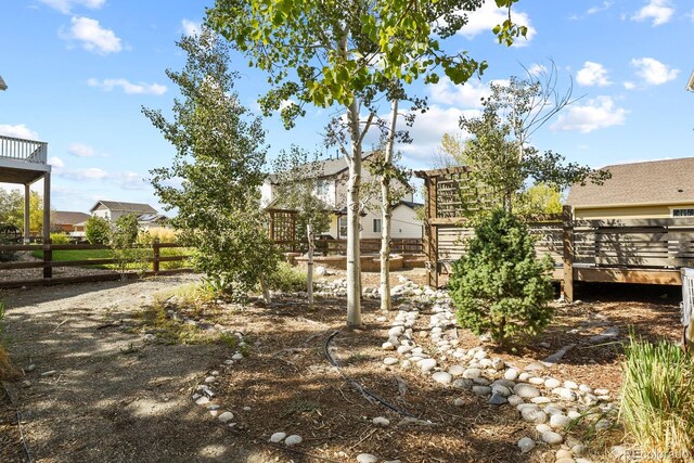 view of yard featuring a wooden deck