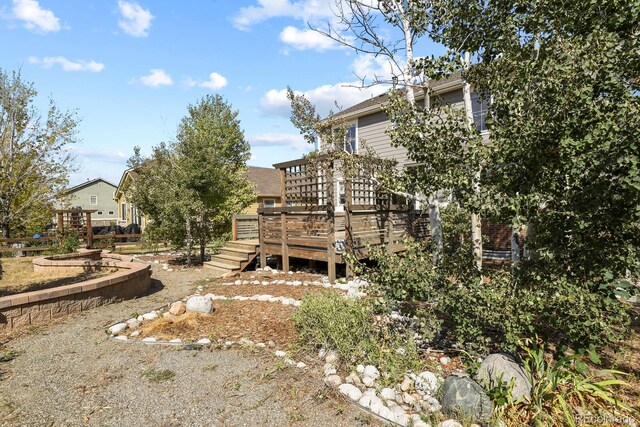 rear view of property featuring a wooden deck