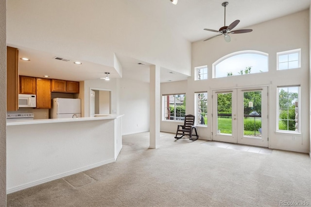 10725 Eliot Cir Unit 102, Denver, CO 80234 - living area with light colored carpet, a towering ceiling, a ceiling fan, baseboards, and recessed lighting