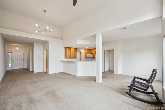 10725 Eliot Cir Unit 102, Denver, CO 80234 - unfurnished living room with light colored carpet, baseboards, a chandelier, and a high ceiling