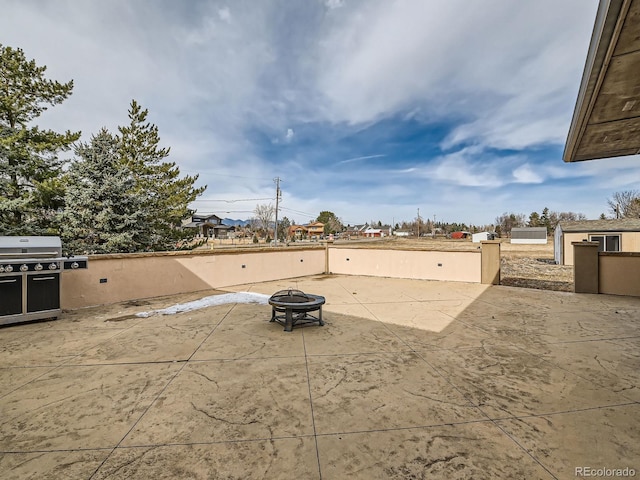 view of patio featuring an outdoor fire pit