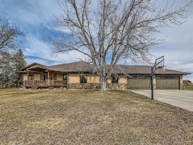 ranch-style home with stone siding, a garage, concrete driveway, a front lawn, and stucco siding