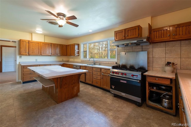 4586 N 95th St, Lafayette, CO 80026 - kitchen featuring under cabinet range hood, designer range, light countertops, ceiling fan, and brown cabinets