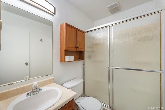 full bath featuring toilet, a stall shower, vanity, and visible vents