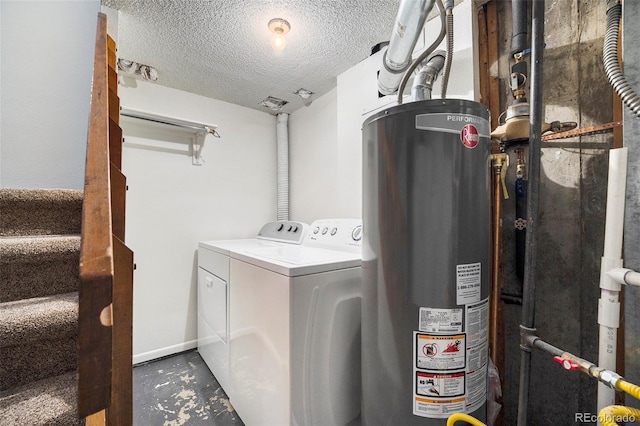 laundry area with water heater, laundry area, a textured ceiling, and washer and dryer