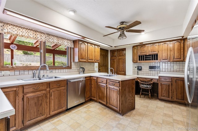 4 Pine Rd, Colorado Springs, CO 80906 - kitchen featuring appliances with stainless steel finishes, a sink, brown cabinetry, and a ceiling fan