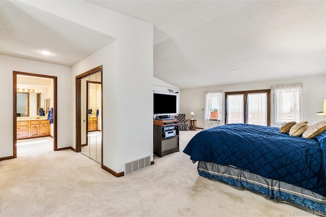 4 Pine Rd, Colorado Springs, CO 80906 - bedroom with light carpet, baseboards, a textured ceiling, ensuite bath, and lofted ceiling