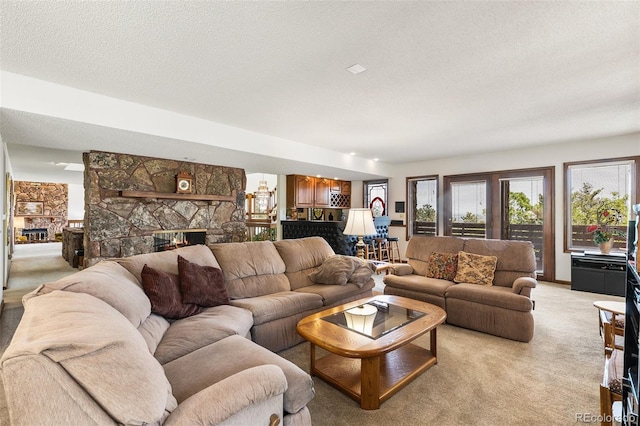 4 Pine Rd, Colorado Springs, CO 80906 - living area featuring a fireplace, light colored carpet, a textured ceiling, and a chandelier