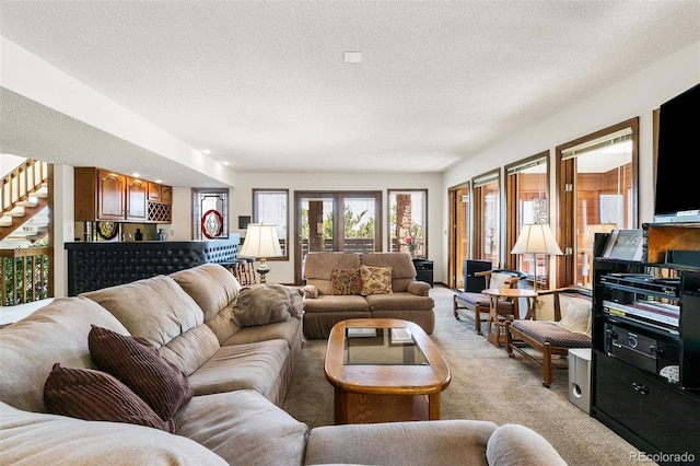 4 Pine Rd, Colorado Springs, CO 80906 - living area featuring light carpet, a textured ceiling, and stairs