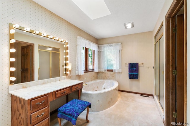 4 Pine Rd, Colorado Springs, CO 80906 - full bathroom with a tub with jets, vanity, a skylight, a stall shower, and baseboards