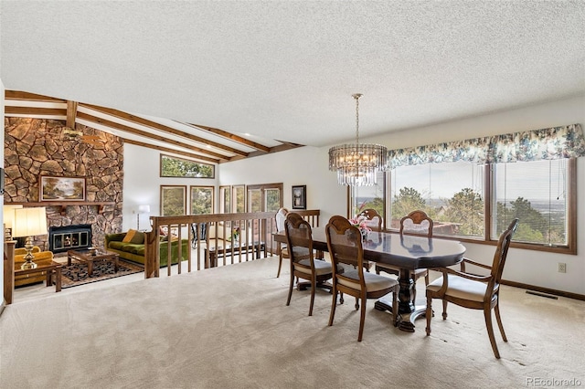 4 Pine Rd, Colorado Springs, CO 80906 - dining room featuring a textured ceiling, a chandelier, carpet flooring, and a fireplace