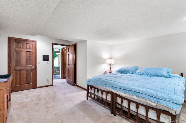 4 Pine Rd, Colorado Springs, CO 80906 - bedroom featuring light carpet, a textured ceiling, and baseboards