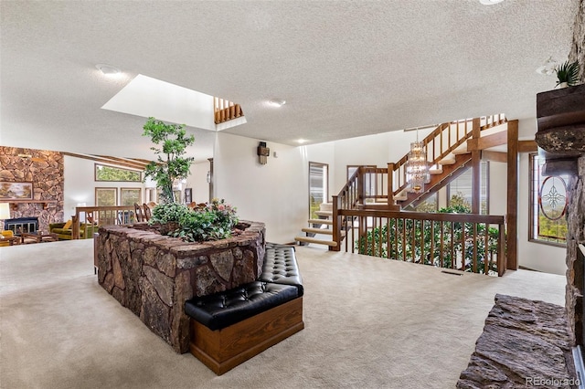 4 Pine Rd, Colorado Springs, CO 80906 - carpeted living area with a textured ceiling and stairway