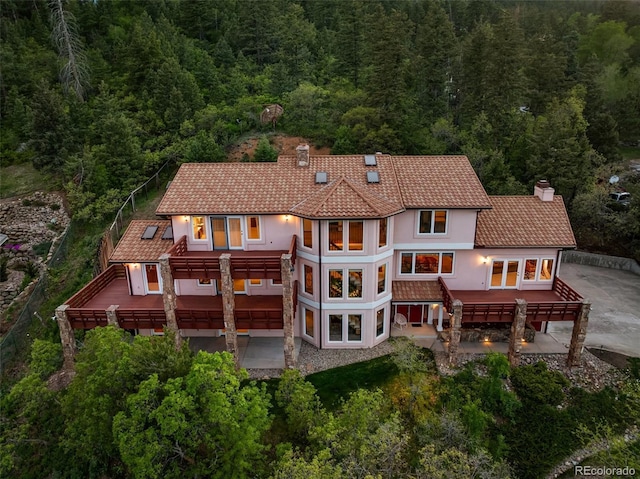 4 Pine Rd, Colorado Springs, CO 80906 - rear view of house featuring a chimney, a pergola, and a view of trees