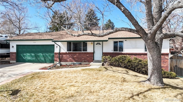 ranch-style home featuring fence, concrete driveway, a front yard, a garage, and brick siding