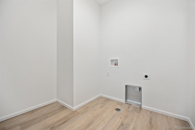 clothes washing area featuring washer hookup, light hardwood / wood-style flooring, and electric dryer hookup