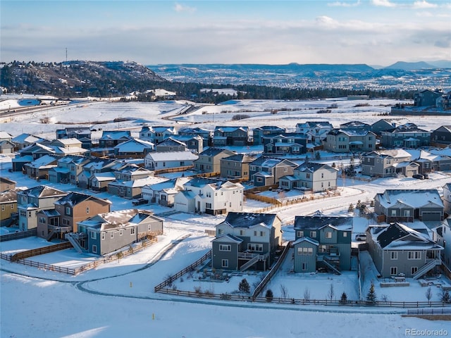 snowy aerial view with a mountain view