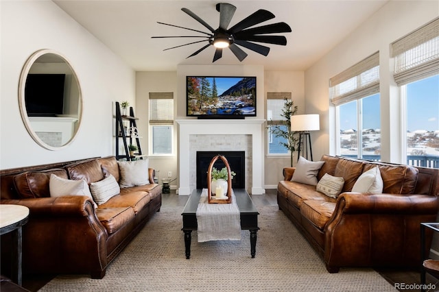 living room with hardwood / wood-style flooring, a tile fireplace, and ceiling fan