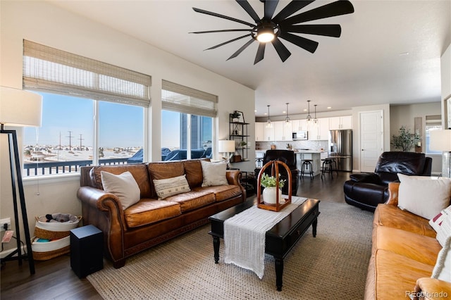 living room with a water view, ceiling fan, and dark hardwood / wood-style floors