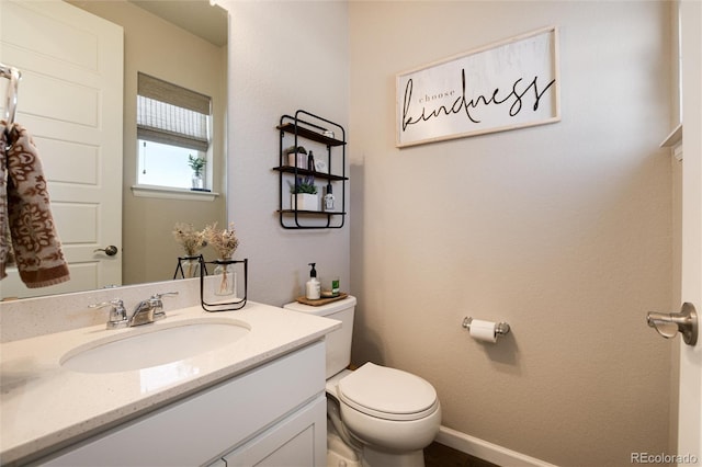 bathroom featuring toilet and vanity