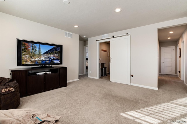 living room featuring light carpet and a barn door