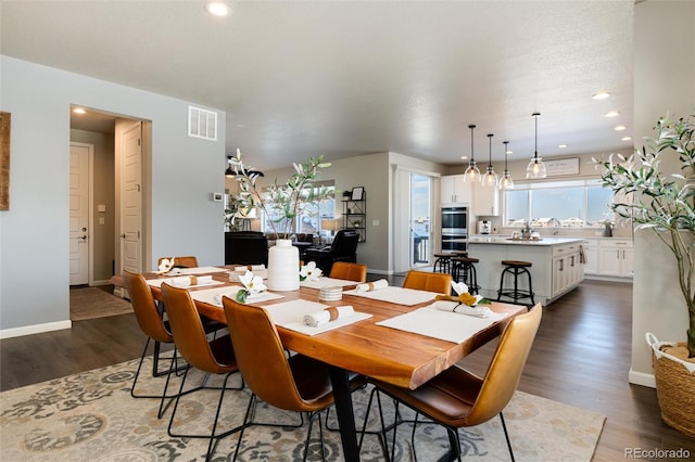 dining space featuring dark hardwood / wood-style flooring