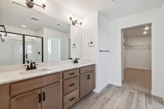 bathroom with vanity, wood-type flooring, and walk in shower