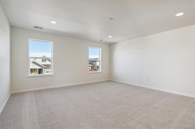 carpeted spare room with plenty of natural light