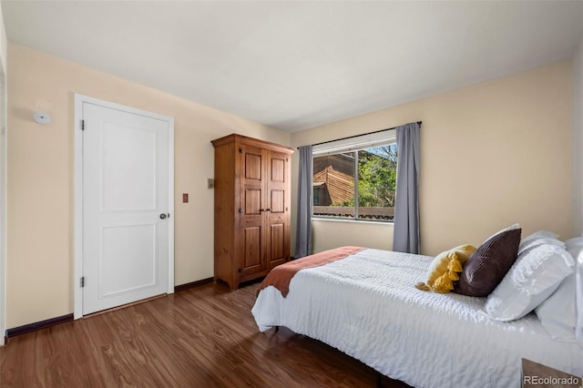 bedroom featuring wood finished floors and baseboards
