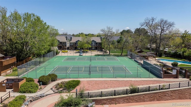 view of tennis court with fence