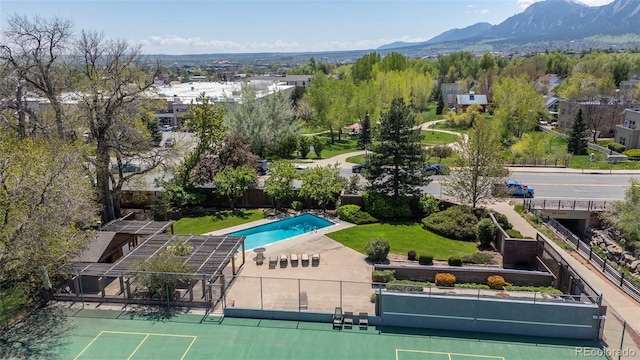 drone / aerial view of a pool area and a mountainous background
