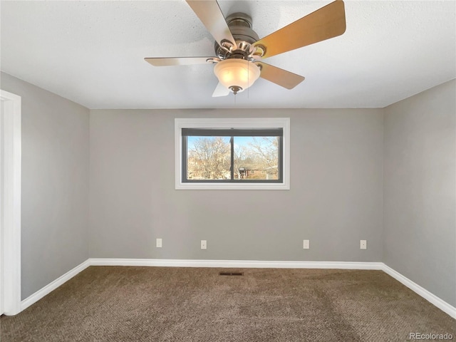 carpeted spare room featuring ceiling fan