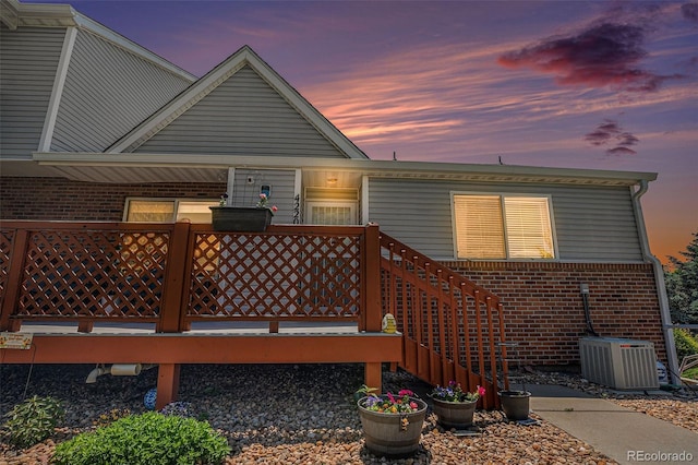 4220 E 119th Pl Unit A, Thornton, CO 80233 - rear view of house featuring brick siding and a wooden deck