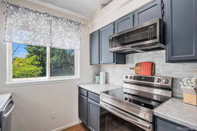 4220 E 119th Pl Unit A, Thornton, CO 80233 - kitchen with stainless steel appliances, light countertops, and backsplash