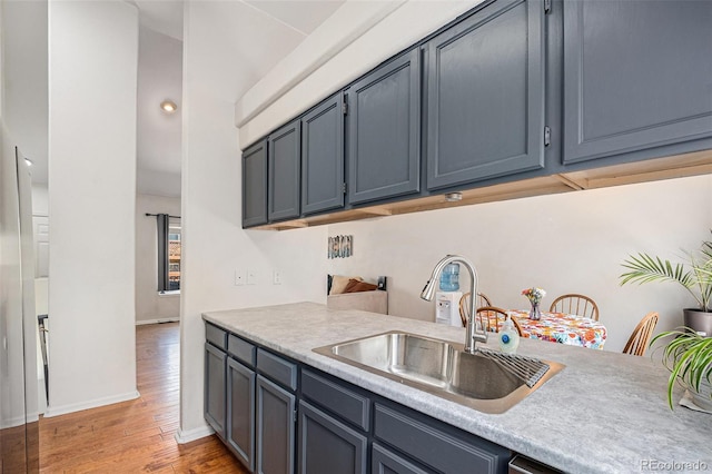 4220 E 119th Pl Unit A, Thornton, CO 80233 - kitchen featuring light countertops and light wood-type flooring
