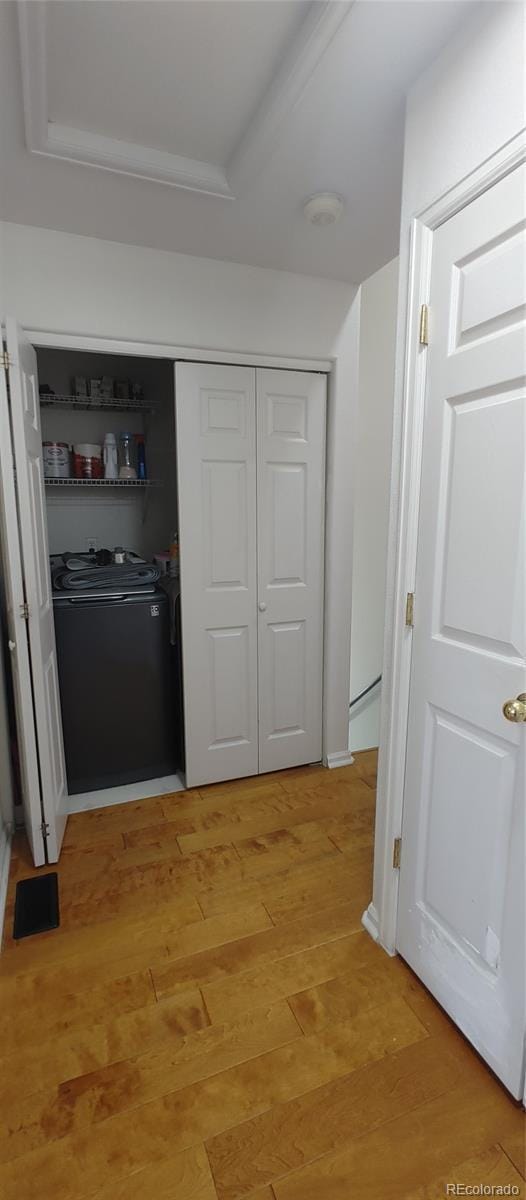 4220 E 119th Pl Unit A, Thornton, CO 80233 - hallway featuring washer / clothes dryer and light wood-style flooring