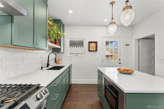 3059 N Humboldt St, Denver, CO 80205 - kitchen with green cabinets, a sink, dark wood-style flooring, light countertops, and recessed lighting