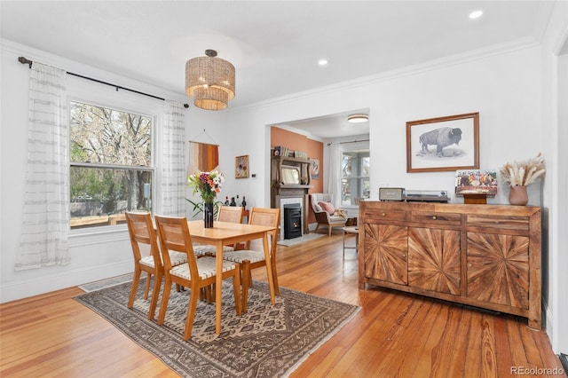 3059 N Humboldt St, Denver, CO 80205 - dining space featuring light wood-style floors, a fireplace with flush hearth, ornamental molding, recessed lighting, and a chandelier
